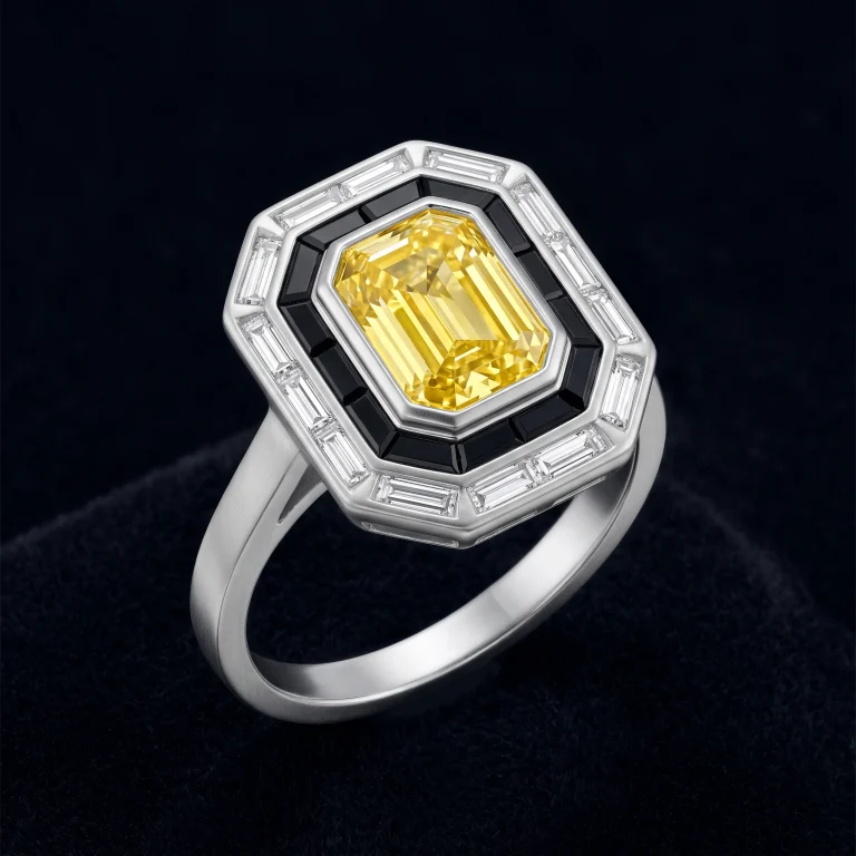 matte platinum Art Deco cocktail ring with emerald-cut yellow diamond, black spinel, and white diamond baguette halo