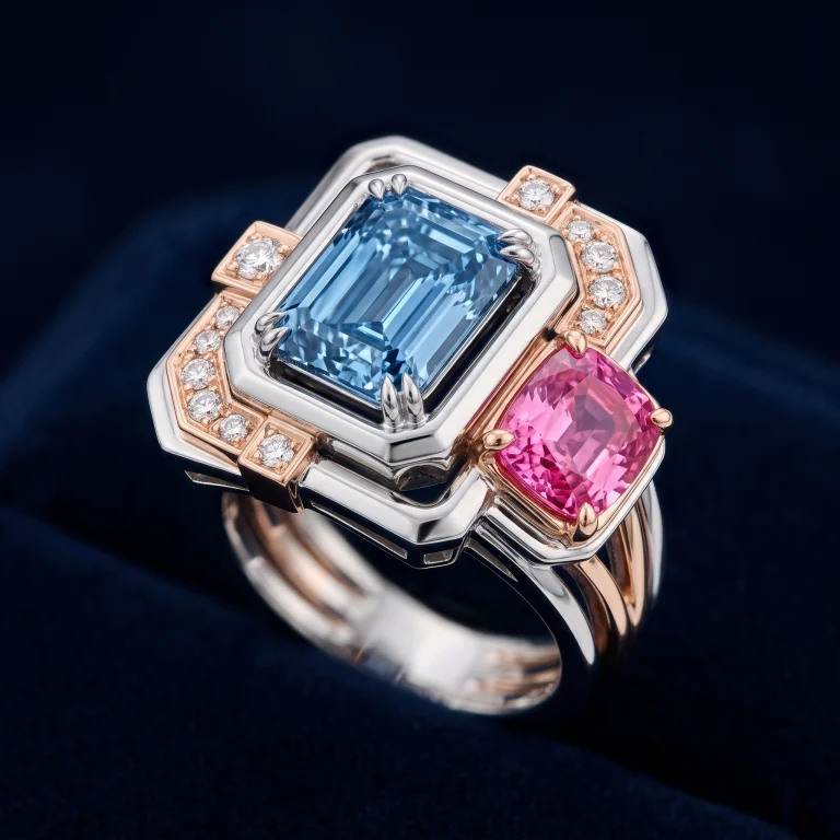 Sculptural platinum and rose gold cocktail ring with emerald-cut blue lab-grown diamond and cushion pink sapphire